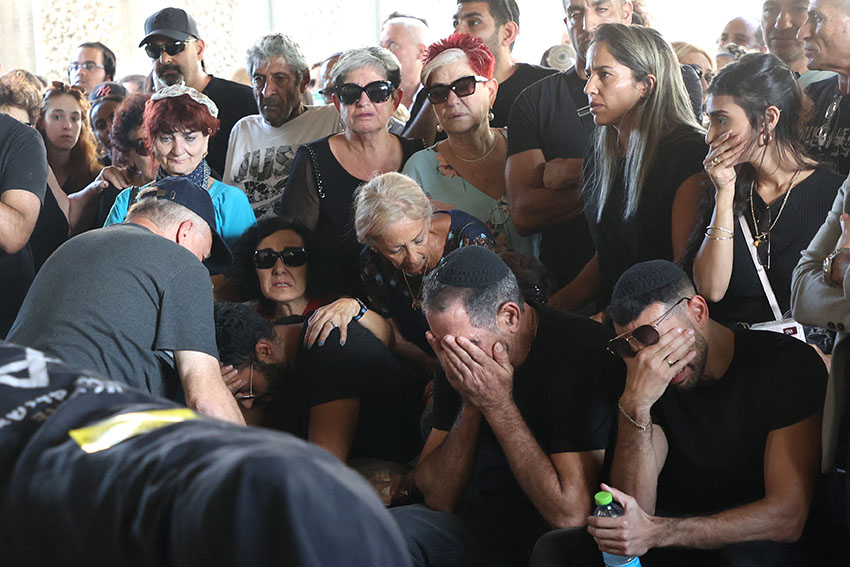Relatives and friends mourn over the body of Israeli-French citizen Celine Ben David Nagar at her funeral near Tel-Aviv. Photo by Gil CohenMagen / AFP