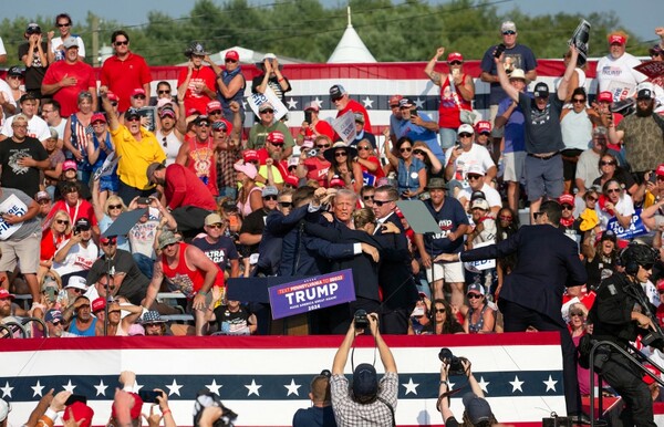 Republican candidate Donald Trump is seen with what appears to be blood on his face surrounded by secret service agents as he is taken off the stage at a campaign event at Butler Farm Show Inc. in Butler, Pennsylvania, July 13, 2024.