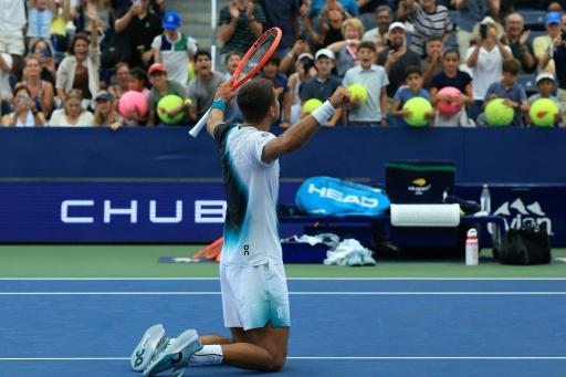 Italy's Flavio Cobolli celebrates after beating Argentina's Francisco Comesana in five sets — TIMOTHY A. CLARY / AFP