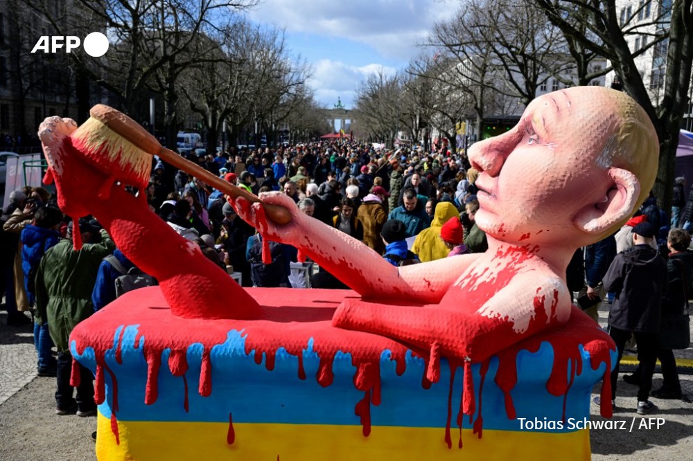 An effigy of Russian President Vladimir Putin bathing in a bath of blood is seen at a rally in front of the Russian embassy in Berlin