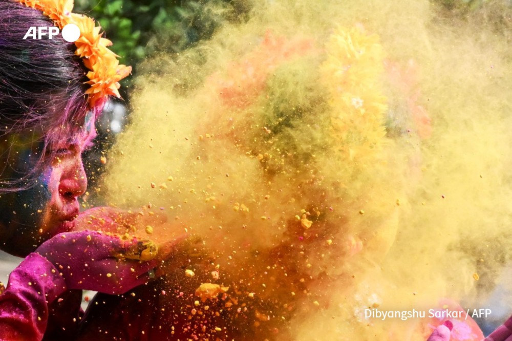 A woman is smeared with ‘Gulal' as she celebrates Holi, the Hindu spring festival of colours, in Kolkata