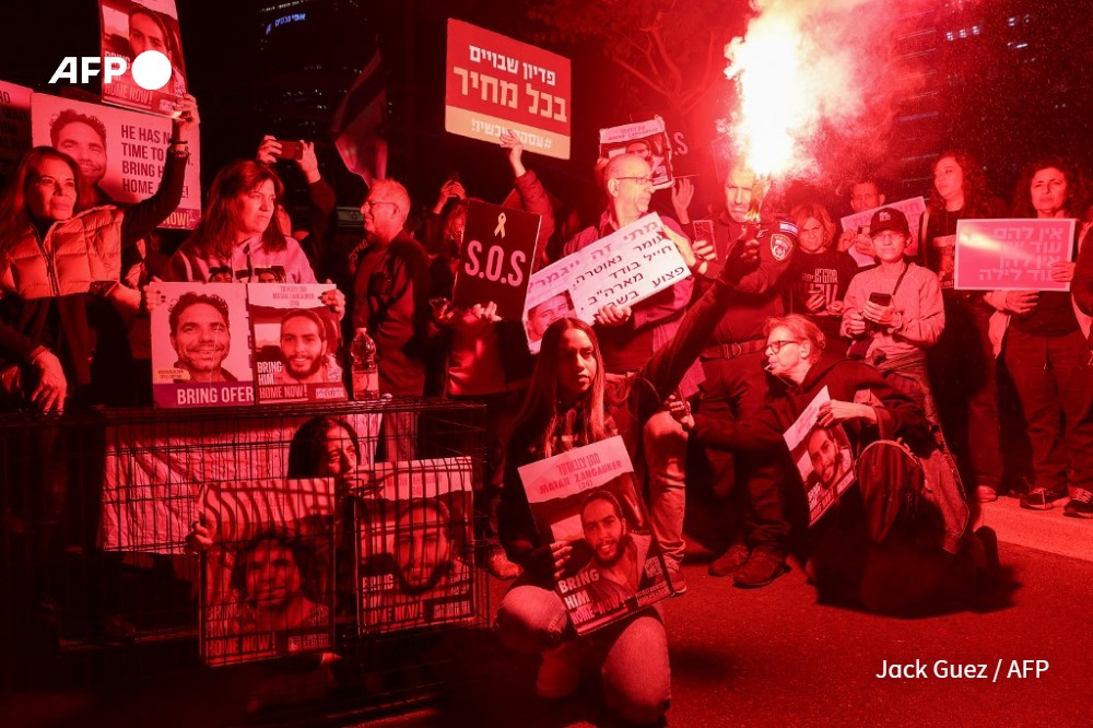 Relatives and supporters of Israeli hostages held in Gaza since the October 7 attacks by Hamas militants, hold placards during a demonstration in Tel Aviv