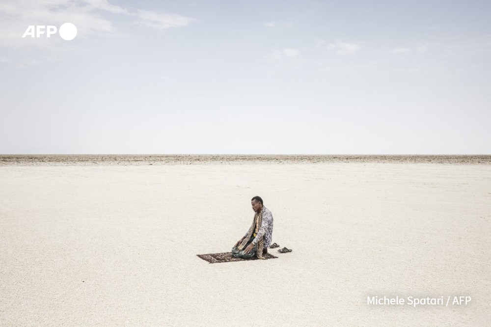 A man prays during Ramadan in the middle of the salt Lake Karum, in the Danakil Depression of the Afar region