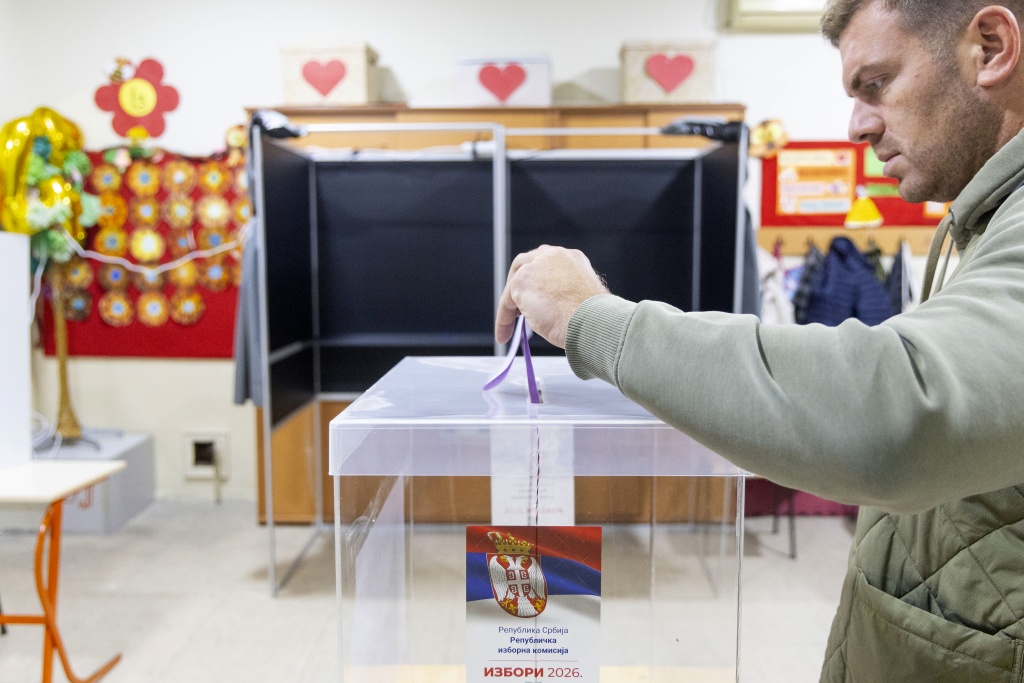 A voter casts a ballot at a polling station for Serbia's snap parliamentary elections — Milos Milanovic / AFP