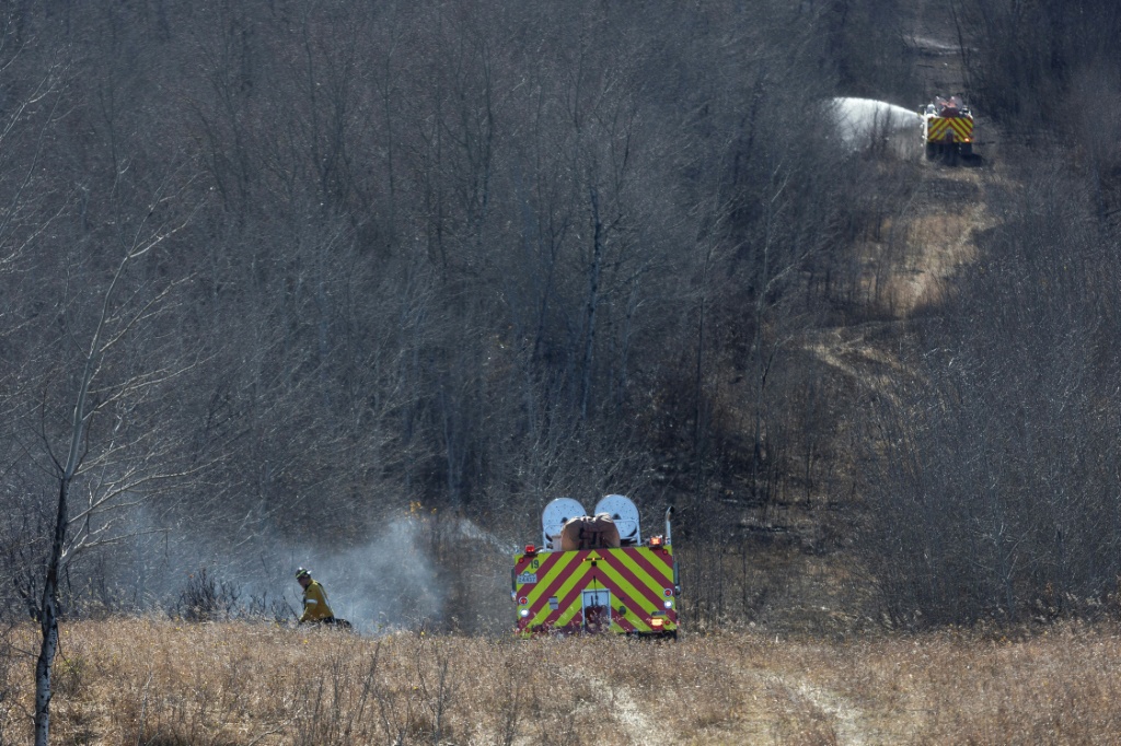 Firefighters continue to work to extinguish flames near Canadian Forces Base Wainwright — Megan Albu / AFP