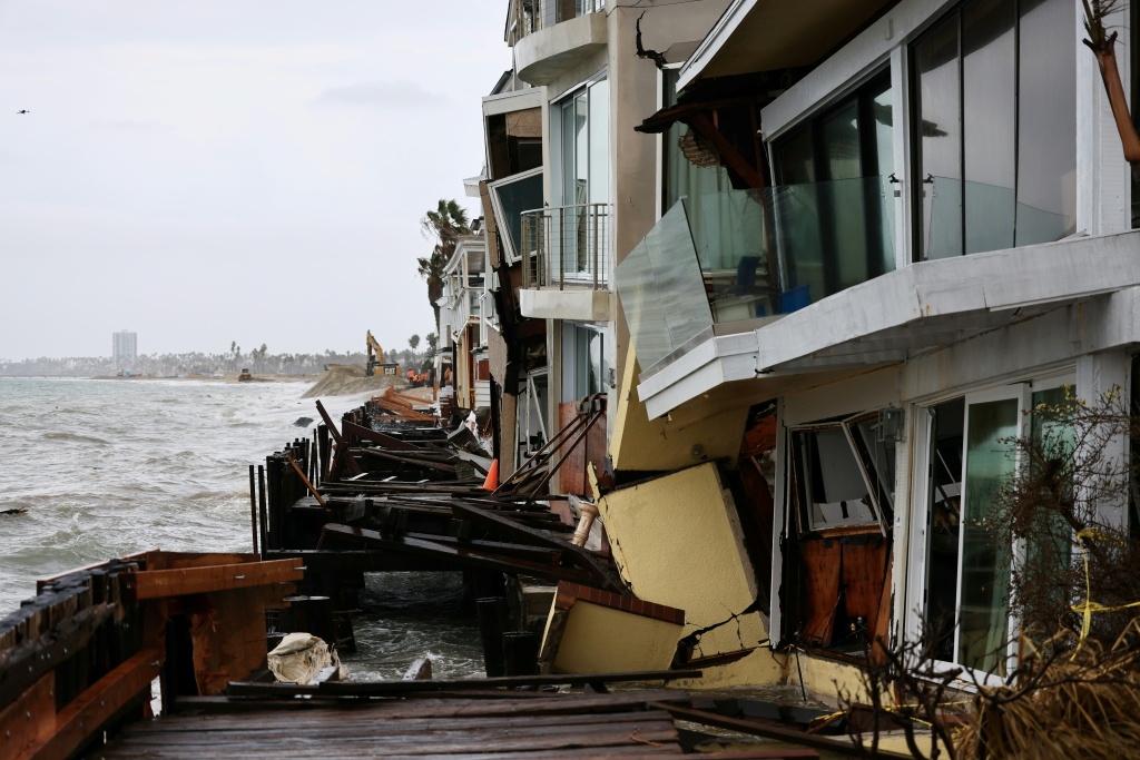 Dramatic photos and video footage showed homes along the city's peninsula teetering precariously, while its historic boardwalk was partially swept away — David Swanson / AFP
