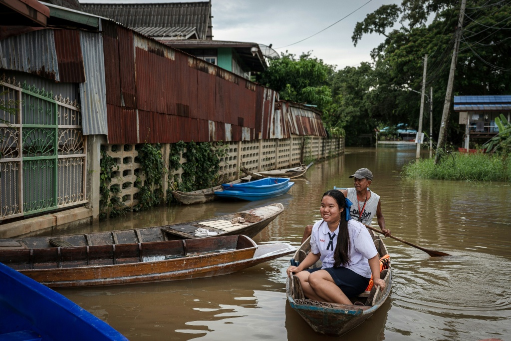 Some argue that a 'flood-free tax' on residents who benefit from flood defences would help impacted families raise their homes and repair damage — Chanakarn LAOSARAKHAM / AFP