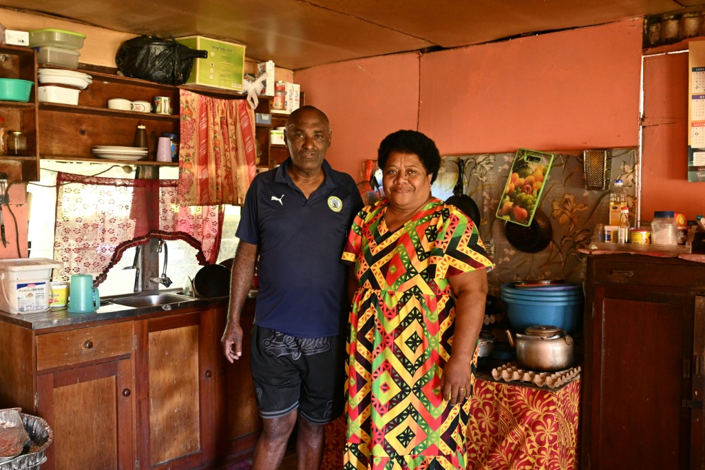 This photo taken on October 9, 2026 shows Vereniki Nalio and his wife, Salaseini Nalio, posing in the kitchen of their home in Rukurukulevu village. Nalio says the global energy squeeze since the Middle East war has led more villagers to consider switching to renewables. — Saeed KHAN / AFP