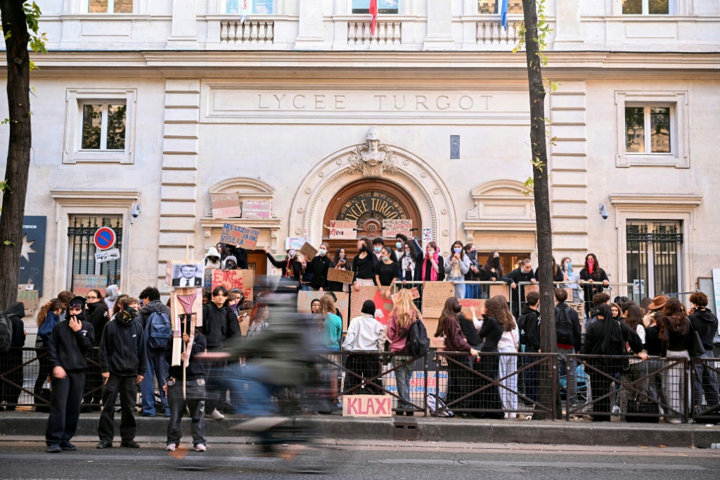 Students protest outside the Turgot secondary school in Paris — LOU BENOIST / AFP