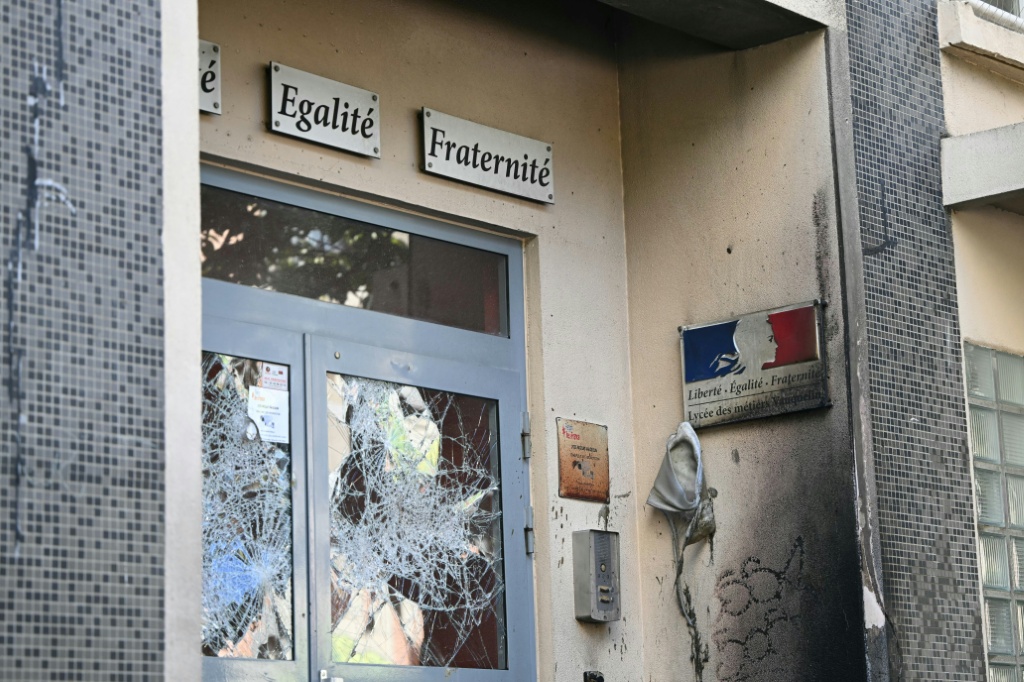 Broken door windows at the Nicolas Louis Vauquelin vocational secondary school in Paris — LOU BENOIST / AFP