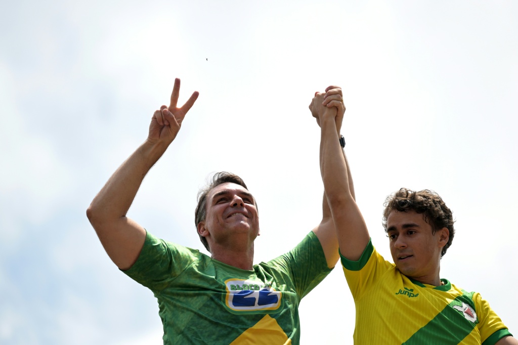 Brazilian senator Flavio Bolsonaro and popular right-wing lawmaker Nikolas Ferreira attend a rally on the eve of the election — DOUGLAS MAGNO / AFP
