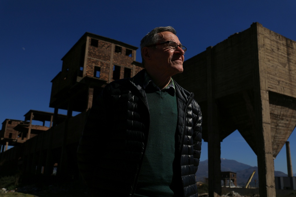 Environmental expert Ahmet Mehmeti in the ruins of Albania's communist-era steelworks in Elbasan — Adnan Beci / AFP
