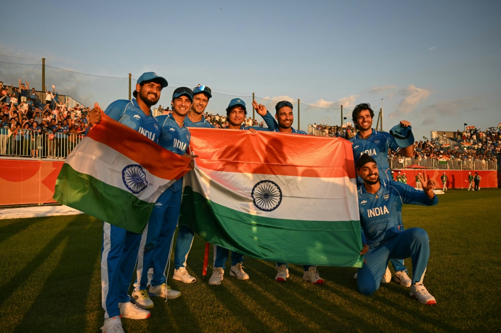 India's players celebrate their victory in the men's cricket final — ANDREW CABALLERO-REYNOLDS / AFP