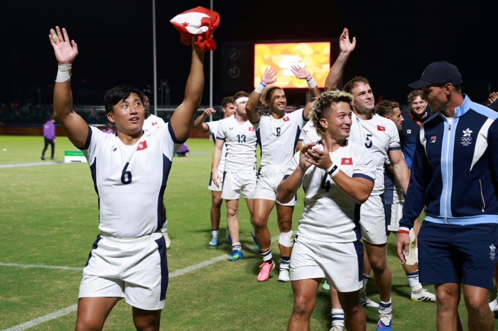 Cado Lee (left) leads the Hong Kong players' celebrations after winning the Asian Games men's rugby sevens for the third time in a row — DAVID GRAY / AFP