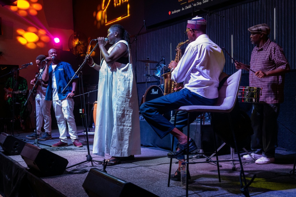 Orchestra Baobab, seen here performing at Just for You in Dakar, has existed for more than 50 years — SEYLLOU / AFP