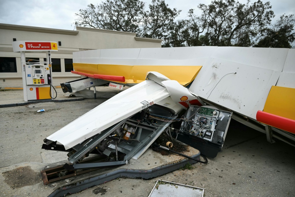 A gas station canopy collapsed in the hurricane-force winds — RONALDO SCHEMIDT / AFP