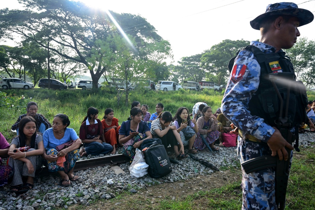 Family members wait outside the Myanmar Navy base in Thanlyin to welcome their loved ones returning from Malaysia — Sai Aung MAIN / AFP