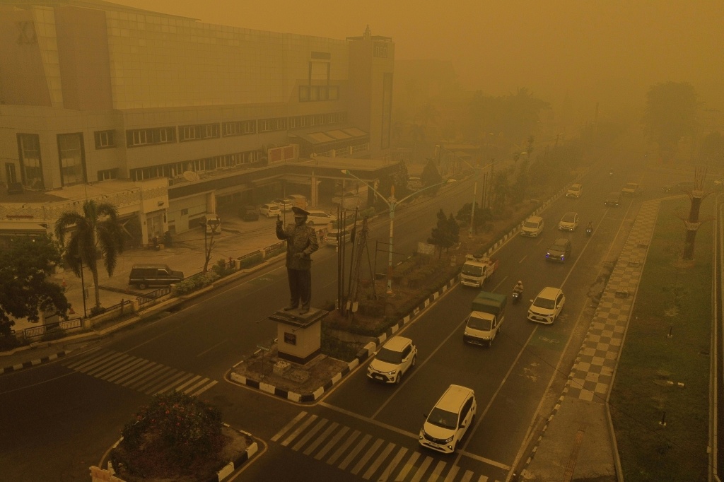 An aerial view shows thick smoke and haze from forest and land fires in the region in Palangkaraya, Central Kalimantan, on October 15, 2026. Toxic haze has covered parts of Indonesia, Malaysia and Singapore for weeks as Jakarta struggles to contain fires that have scorched large tracts of Borneo and Sumatra, with the smoke drifting across the region. — Afan Anugerah / AFP