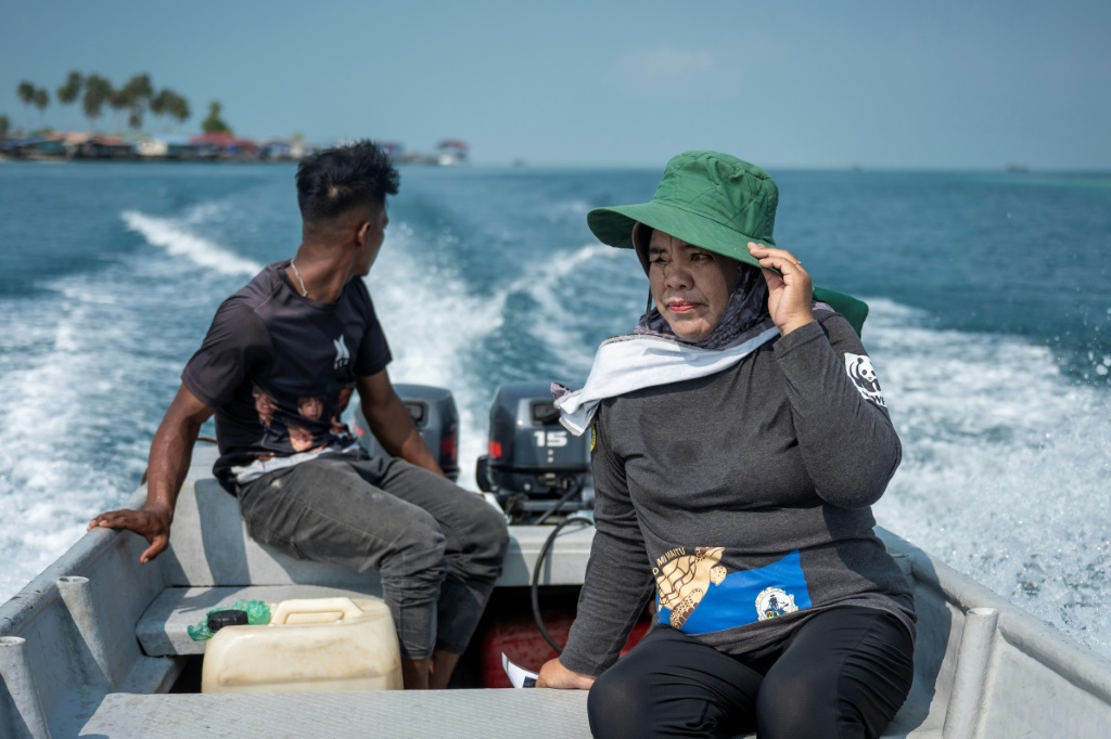 A women's collective on Omadal island patrols daily during turtle nesting season to relocate and protect eggs — SAI AUNG MAIN / AFP