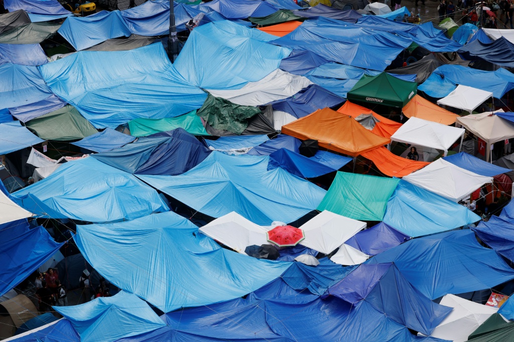 Hundreds of protesters are occupying a tent city in central Madrid to press for reforms — Oscar DEL POZO / AFP