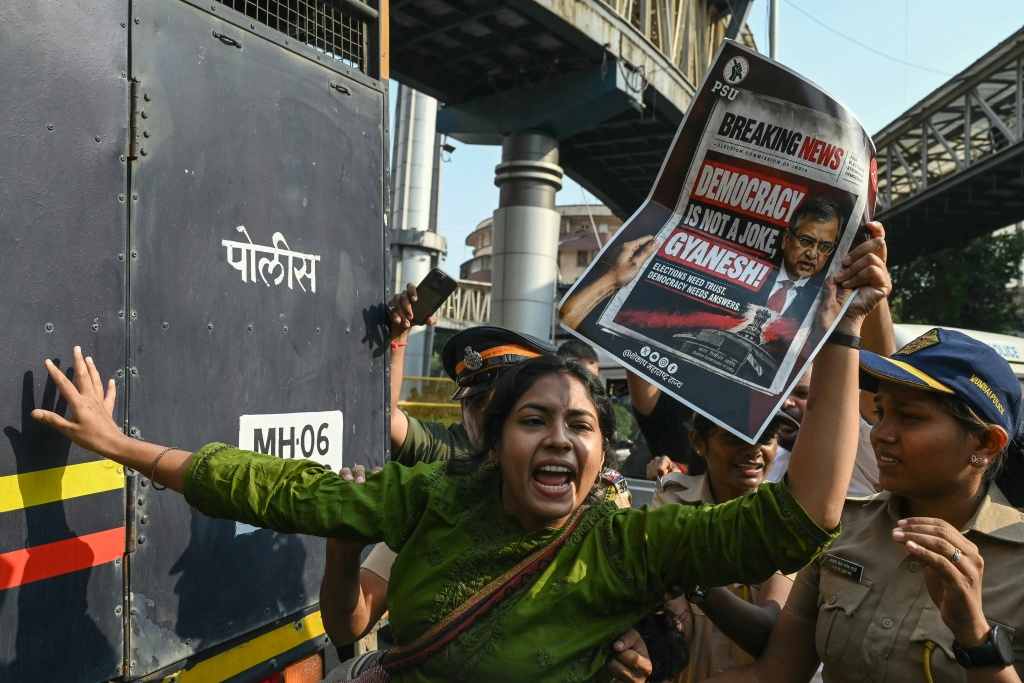 Police detain a supporter of the Cockroach Janata Party movement during a protest in Mumbai — Indranil MUKHERJEE / AFP
