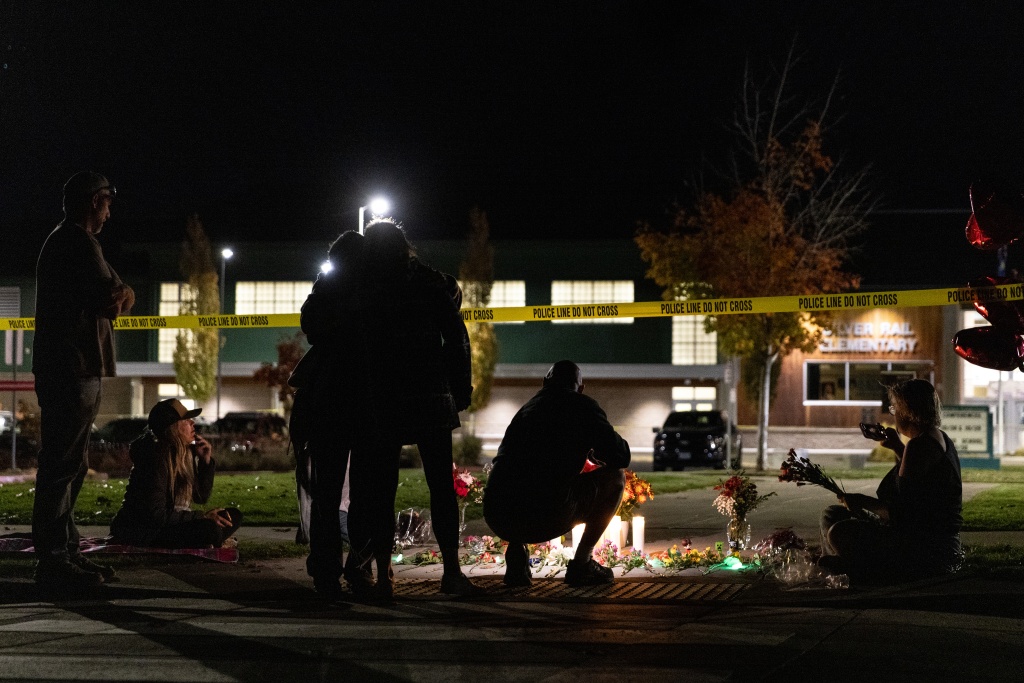 People gather at a makeshift memorial outside the Silver Rail Elementary School in Bend after the shooting — Payton Bruni / AFP