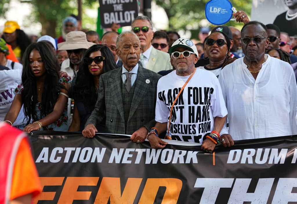US civil rights activist Al Sharpton, pictured (in suit and tie) on an August 2026 march with movie director Spike Lee, says the Trump administration's immigration raids have generated anxiety among African Americans — Aaron Schwartz / AFP