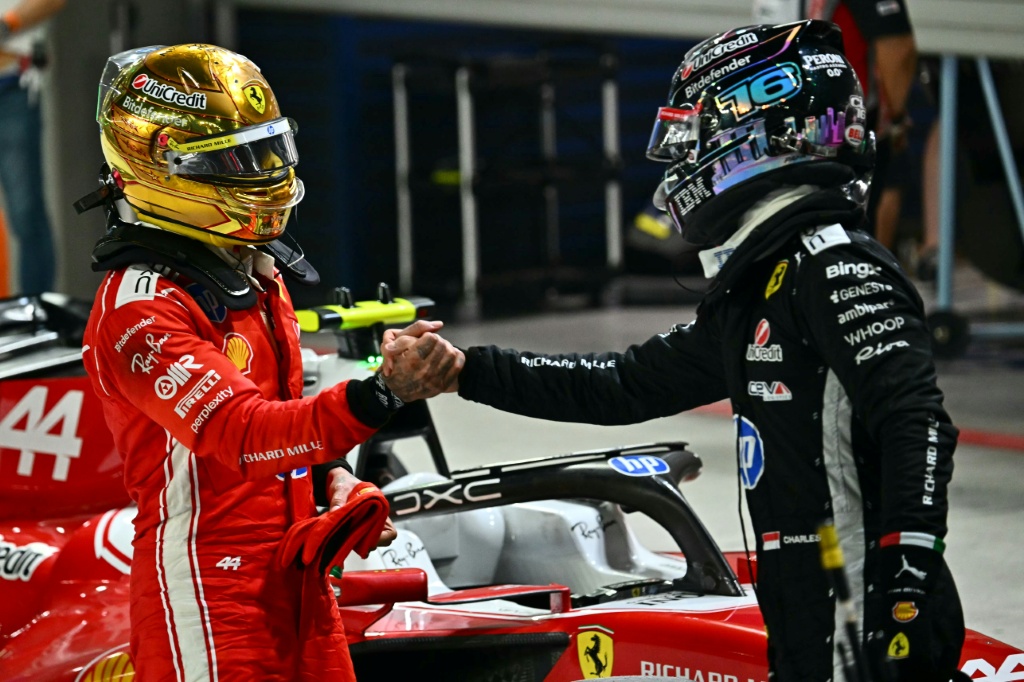 Ferrari's Lewis Hamilton (L) and Charles Leclerc congratulate each other at the end of qualifying for the Singapore Grand Prix — Lillian SUWANRUMPHA / AFP