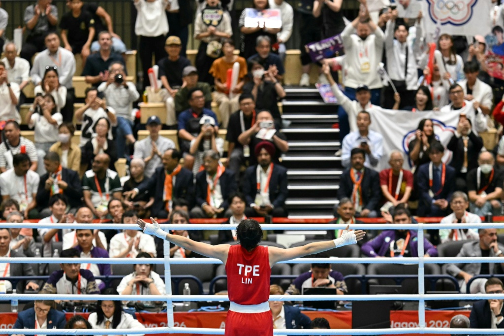 Taiwan's Lin Yu-ting celebrates her victory against China's Yang Chengyu in front of small band of Taiwanese fans — MOHD RASFAN / AFP