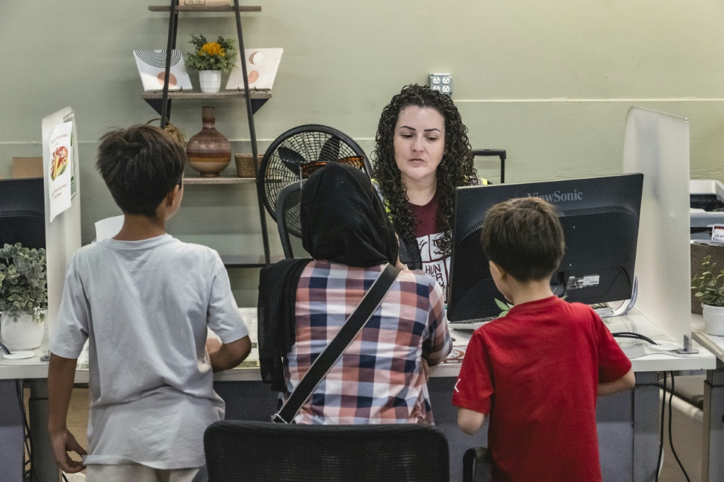 A family registers at an Arizona food bank for assistance — Olivier Touron / AFP