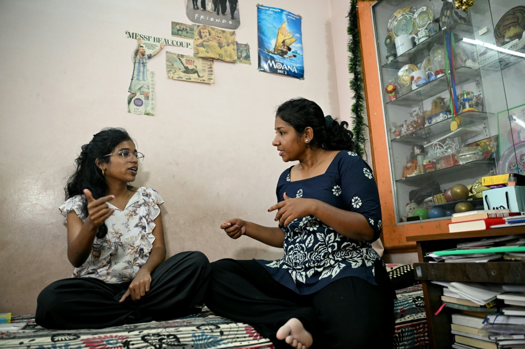 This photograph taken on September 23, 2026 shows rapper Abisha (L), a member of Tamil Nadu's first all-women rap group Sollisai Sistahs, taking part in a jam session with journalist Kavya B at the latter's residence in Bengaluru. — Idrees MOHAMMED / AFP