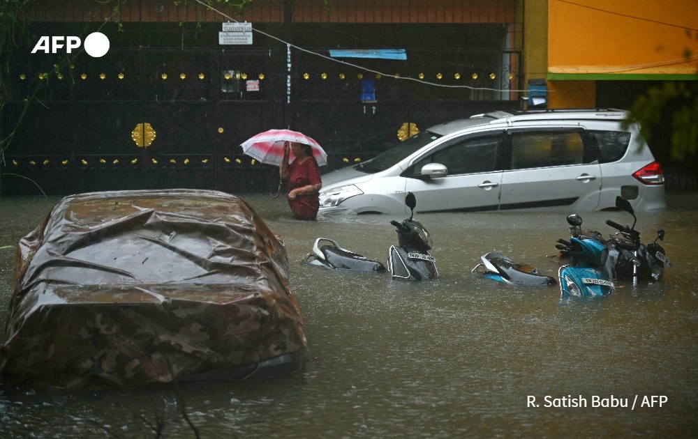 A resident wades through a flooded street