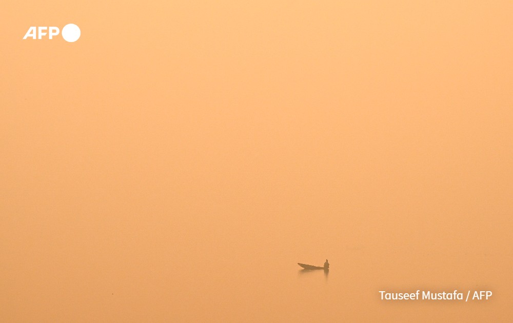 A boat across a lake on a foggy day