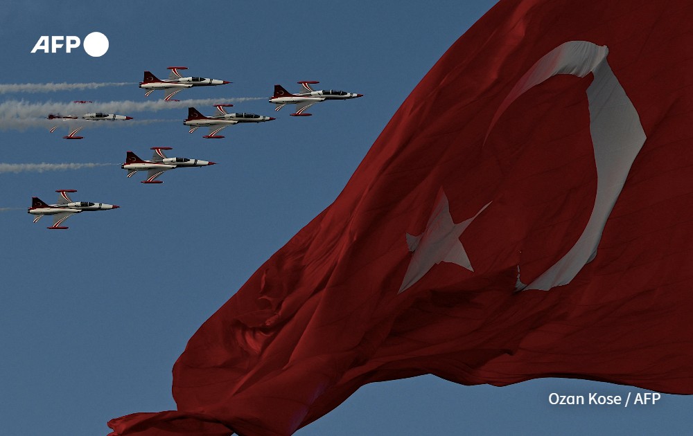Turkish Air force pilots of the 'Turkish Stars' fly in Northrop F-5 near a national flag to mark the 100th anniversary of Turkish Republic