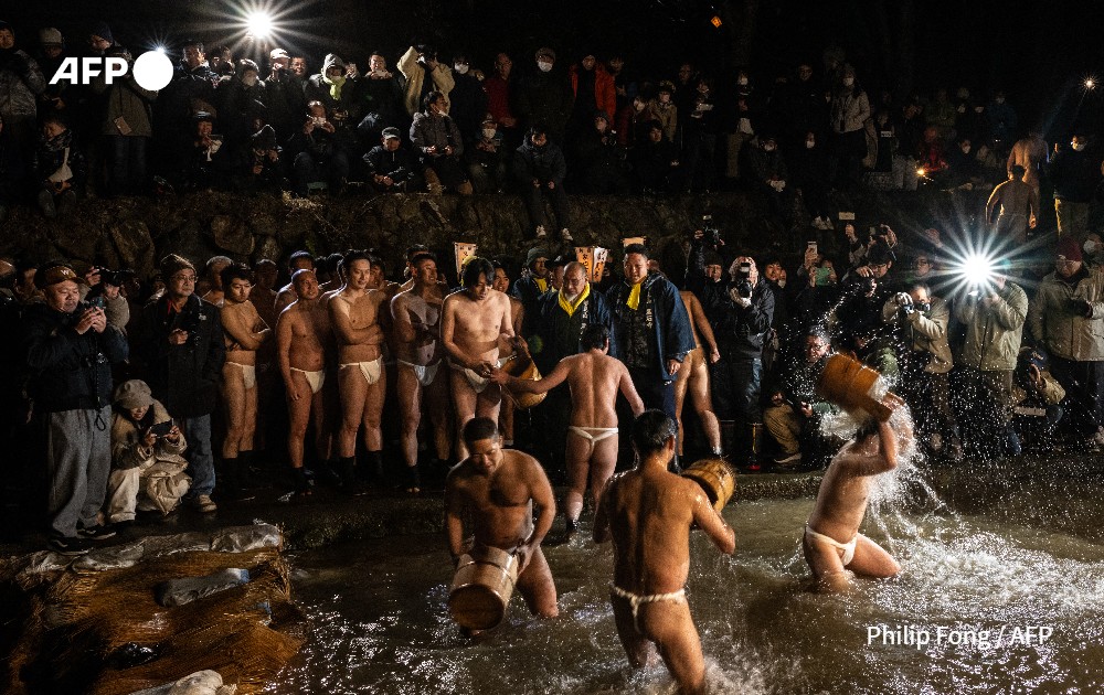 Men cleanse their bodies in a river during the Sominsai Festival