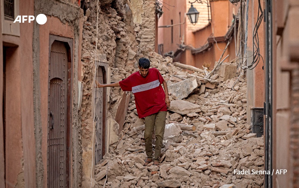 Resident navigates through the rubble following an earthquake