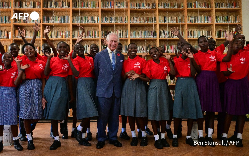 Britain's King Charles III (C) poses for a group photo with participants of the Prince's Trust International