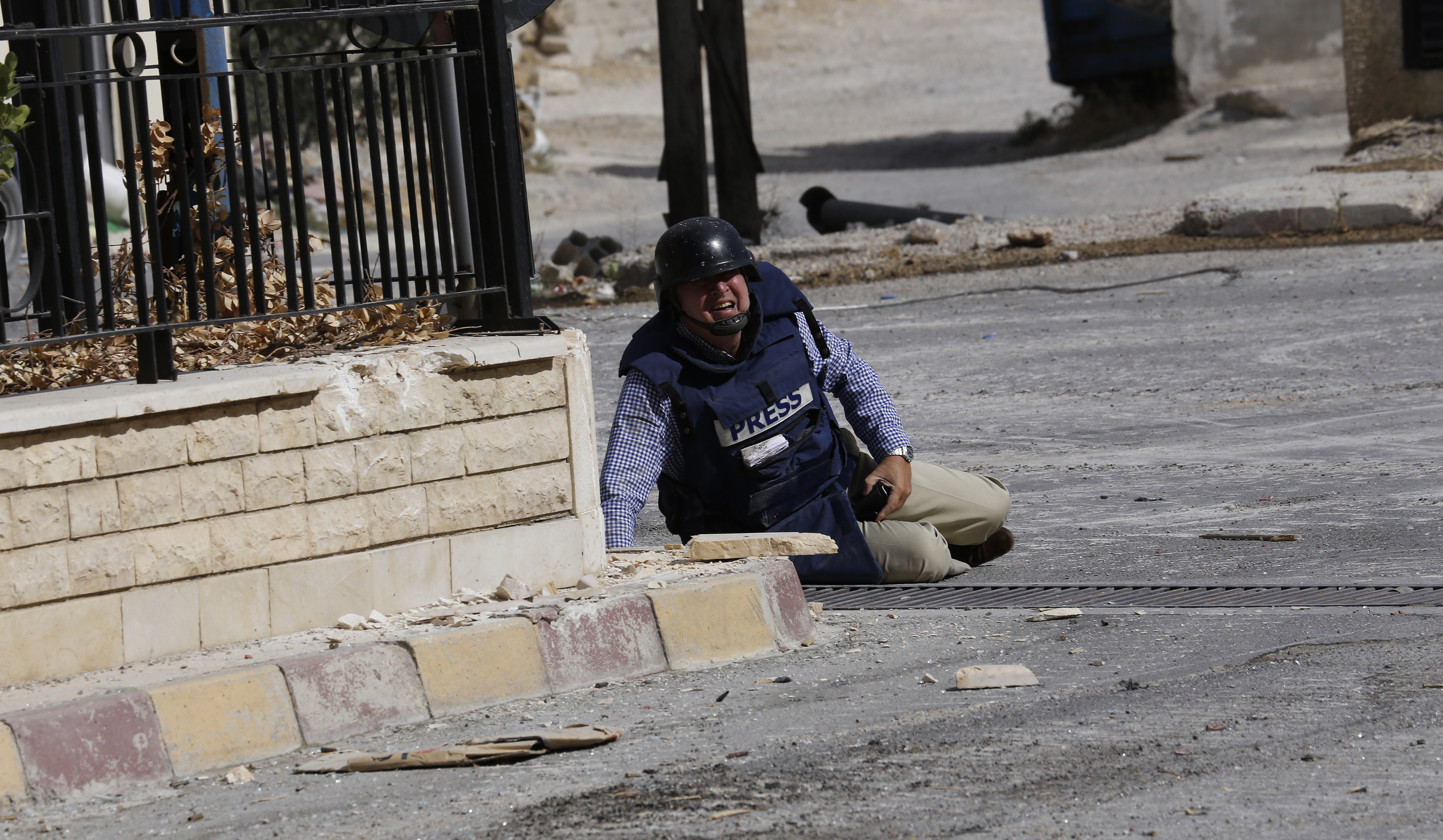 AFP reporter Sammy Ketz lies on the ground during sniper fire in the ancient Christian Syrian town of Maalula, on September 18, 2013 AFP reporter Sammy Ketz lies on the ground during sniper fire in the ancient Christian Syrian town of Maalula, on September 18, 2013