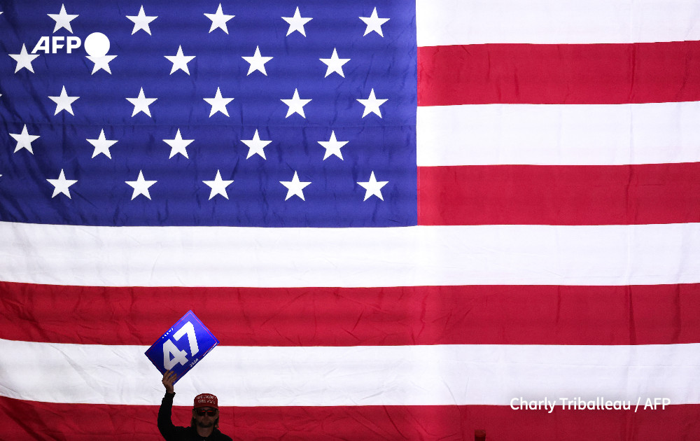 A supporter holds up a 47 sign as former US President and Republican presidential candidate Donald Trump speaks during a town hall at the Convention Center in Lancaster, Pennsylvania, October 20, 2024. 