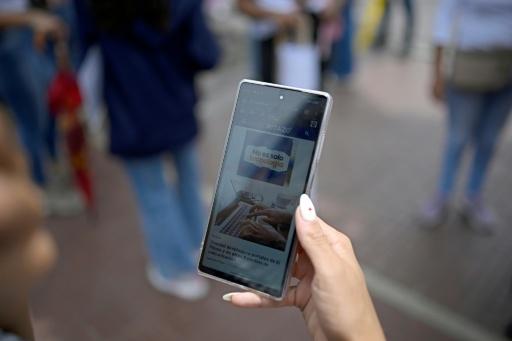 Una mujer lee un artículo del medio informativo venezolano El Pitazo en un teléfono móvil, el 17 de septiembre de 2026 en Caracas — Federico Parra / AFP