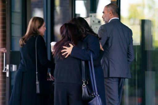 People embrace as they arrive for the sentencing hearing of Canadian poison seller Kenneth Law, who pleaded guilty to 14 counts of aiding suicide, at the Ontario Superior Court of Justice in Newmarket, Ontario, on September 23, 2026 — Arlyn McAdorey / AFP