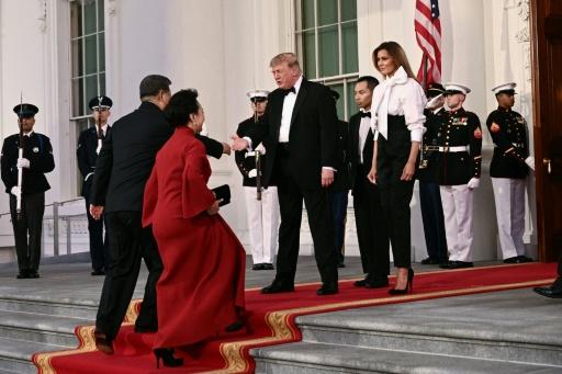 US President Donald Trump and First Lady Melania Trump greet China's President Xi Jinping and his wife Peng Liyuan upon their arrival at the White House for a state dinner — Brendan SMIALOWSKI / AFP
