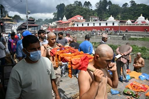 Relatives carry Kush grass effigies for cremation in accordance with Nepali Hindu rites during symbolic funerals held for flood victims — PRAKASH MATHEMA / AFP