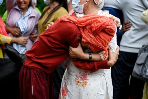 People mourn their missing relatives in the aftermath of flash floods, outside a mortuary in Nepal's Chitwan district — Prakash MATHEMA / AFP