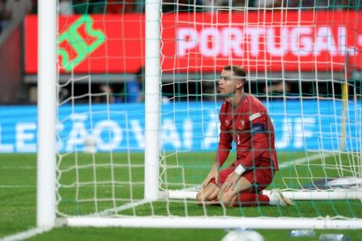 Cristiano Ronaldo sits in the goal after hitting a close-range volley over the Wales bar — PATRICIA DE MELO MOREIRA / AFP