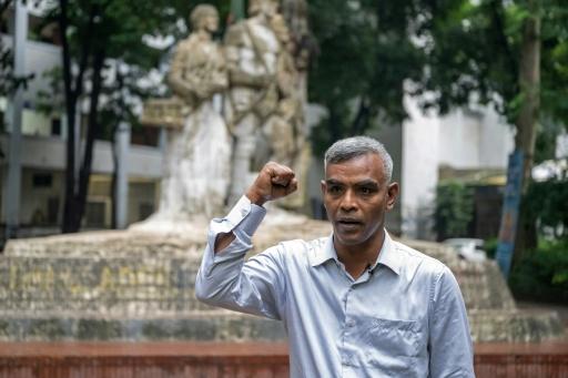 Dhaka University student Abu Tayyab Habildar ripped a photo, exposing a bitter dispute over Bangladesh's history — Salahuddin AHMED / AFP