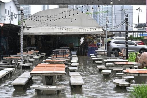 A person wades through floodwaters in the Bang Bua district of Bangkok on September 26, 2026. — WIKUS DE WET / AFP