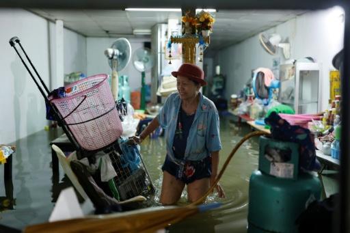 A man looks out from a flooded restaurant in Bangkok on September 26, 2026 — Lillian SUWANRUMPHA / AFP