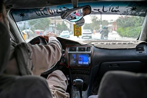 A radio can be seen in an taxi transporting passengers in Kabul — Wakil KOHSAR / AFP