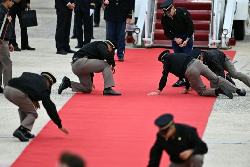 Military personnel unrolled the red carpet at the bottom of the stairs of the Air China plane carrying Chinese President Xi Jinping — Kent NISHIMURA / AFP